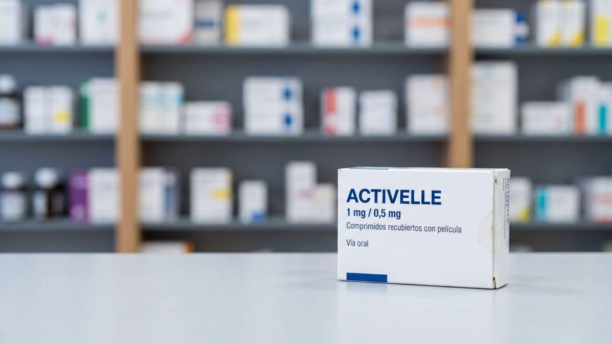 ¿Se puede comprar Activelle sin receta? 3 Caja de Activelle 1 mg / 0,5 mg sobre el mostrador de una farmacia con estanterias al fondo.